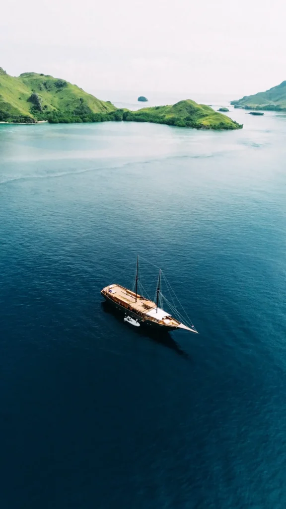 The Angelica phinisi sailing past the islands of Komodo National Park