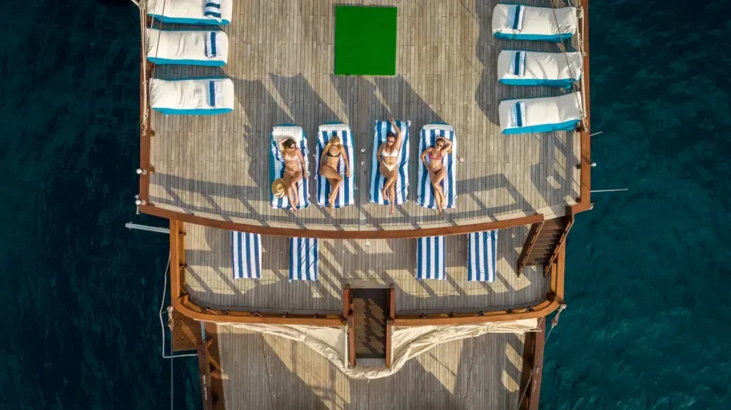 Aerial view of The Maj Oceanic sundeck with sun loungers and shaded lounge area on the upper deck