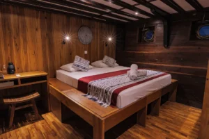 Double-bed setup in a lower-deck cabin aboard Amira