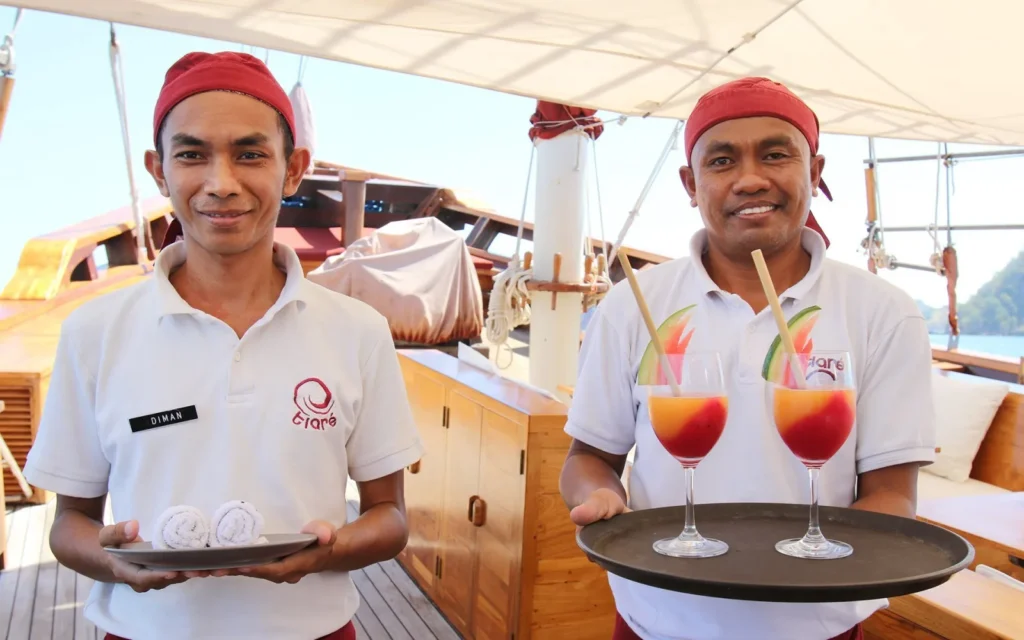 Crew serving guests in an outdoor area aboard Tiare Cruise