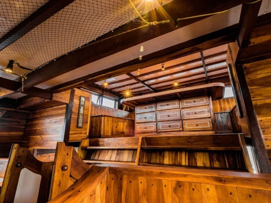 Wooden dining saloon and seating aboard Akomo Isseki