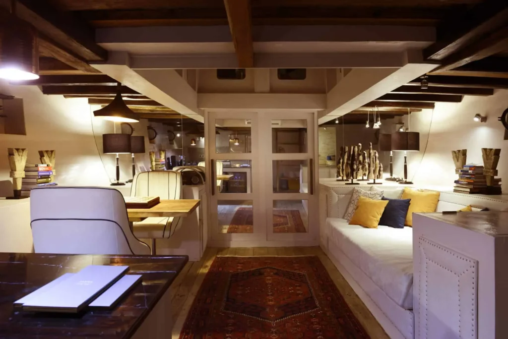 Teak, glass and pale-fabric interior lounge aboard Alexa