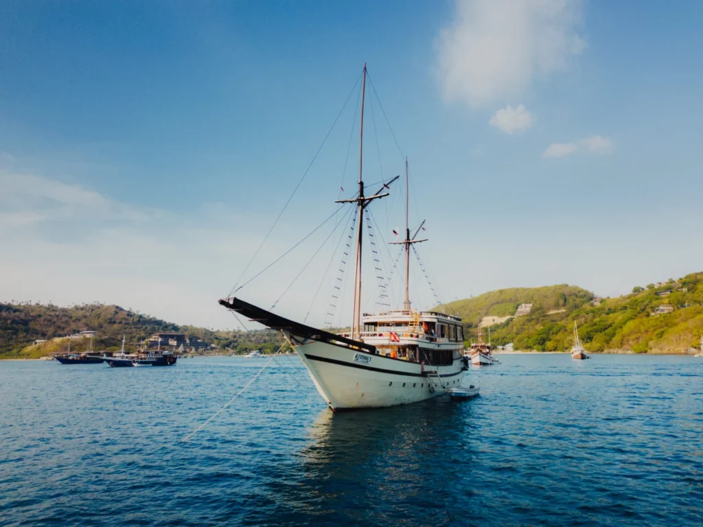 Aerial view of Alfathran 3 phinisi at anchor among the Komodo islands