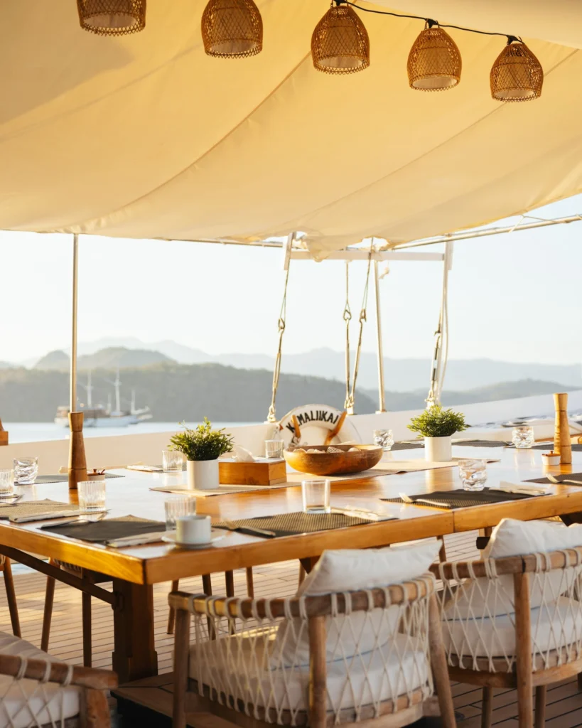 Covered alfresco dining table aboard Aliikai Voyage