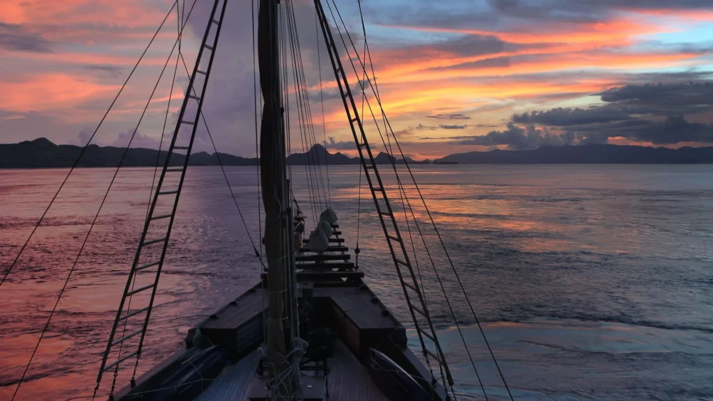 Alila Purnama deck and rigging silhouetted at sunset