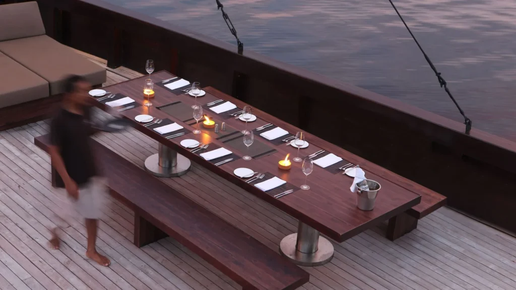 Dining table set on the open deck of Alila Purnama