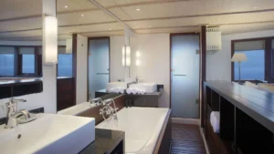 Sriwijaya Master Suite bathroom with bathtub and twin vanities aboard Alila Purnama