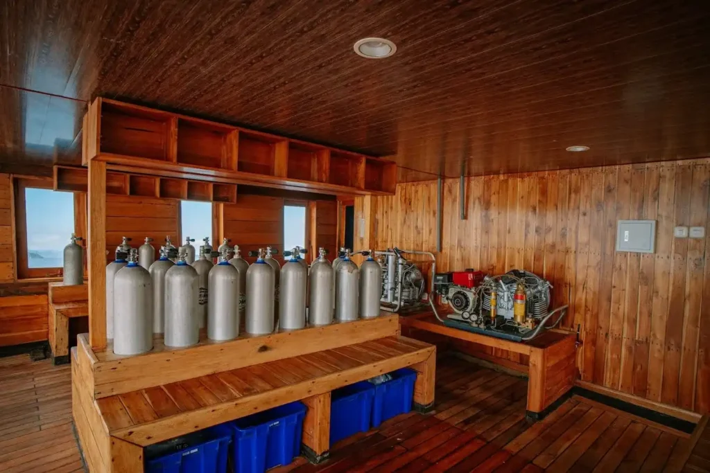 Dive deck with tanks and compressor aboard Alore