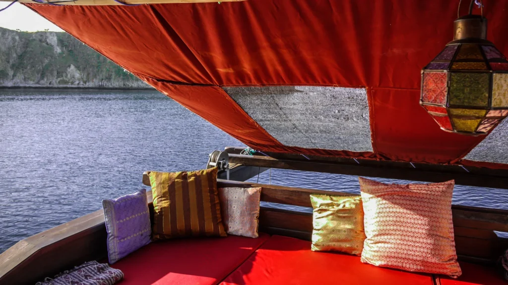 Covered outdoor lounge with daybeds aboard Ananda