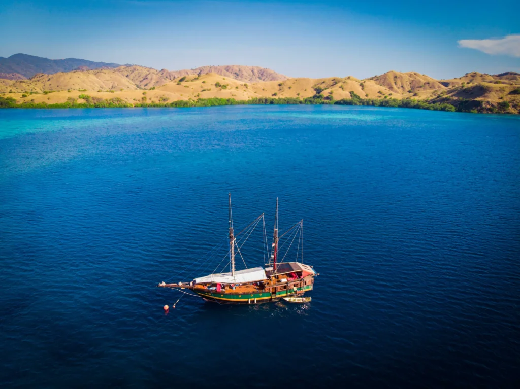 Aerial view of Ananda phinisi anchored by the Komodo islands