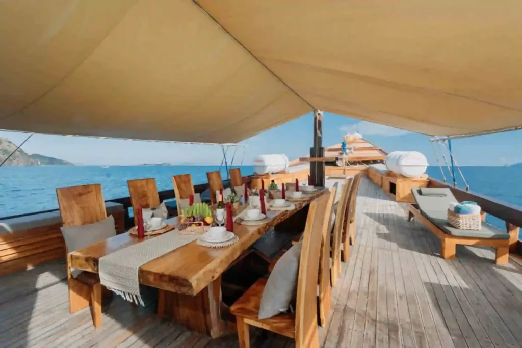 Covered outdoor dining table aboard Andamari