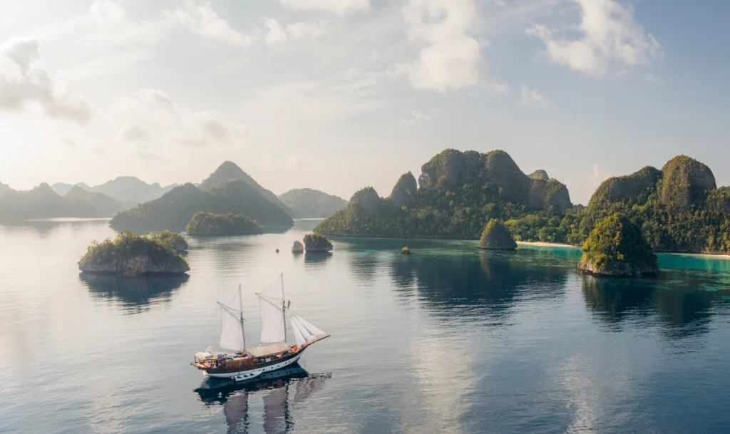Aerial view of Anne Bonny sailing among Raja Ampat islands