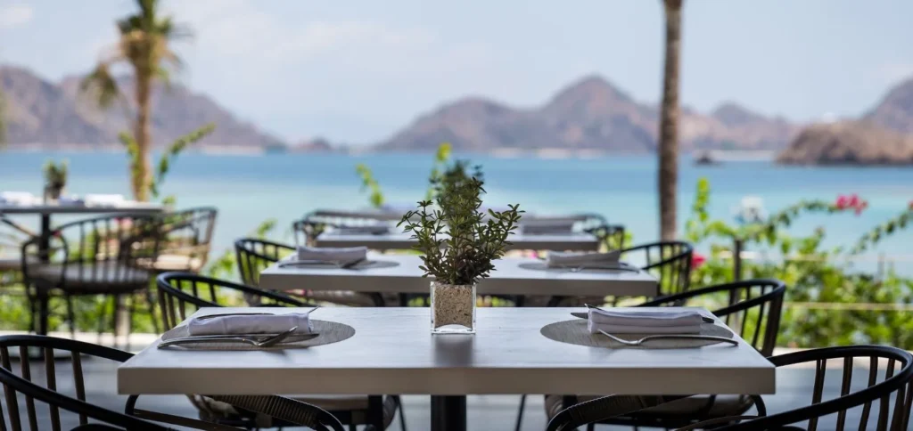Ocean-view dining area at AYANA Komodo Waecicu Beach