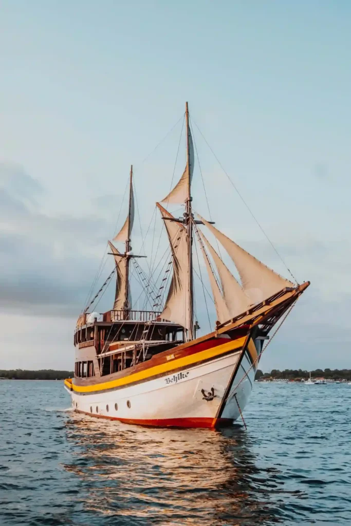 Behike at anchor close in over sand, helped by her two-metre draft