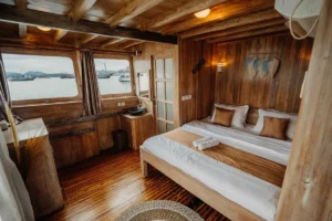 Double-bed cabin interior aboard Cajoma IV with natural light