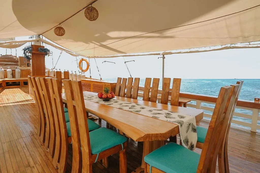 Dining table prepared for guests aboard Cajoma IV phinisi