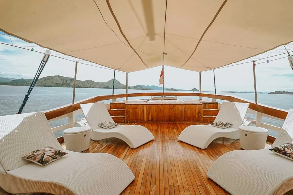 Sun deck relaxation area with mattresses aboard Cajoma IV