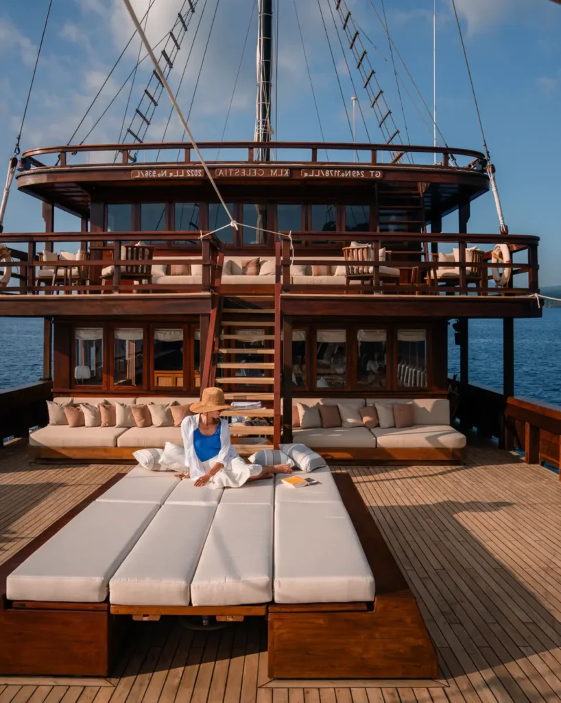 Open main deck of the Celestia phinisi yacht with al fresco dining