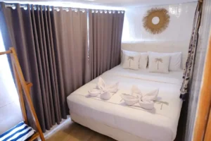 Queen bed inside a Deluxe Ocean View cabin aboard Dua Liveaboard