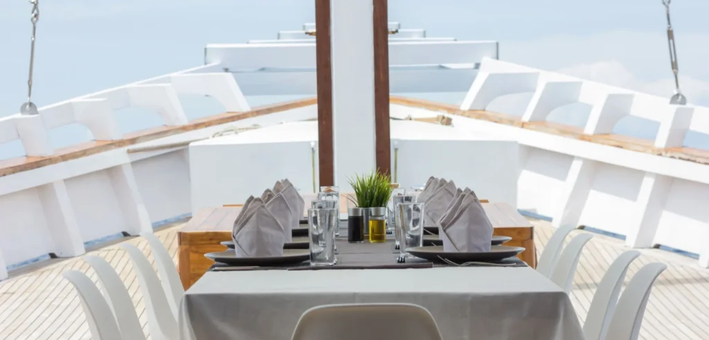 Outdoor dining setup near the bow of Fenides liveaboard