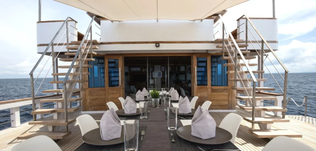 Outdoor dining table aboard Fenides liveaboard
