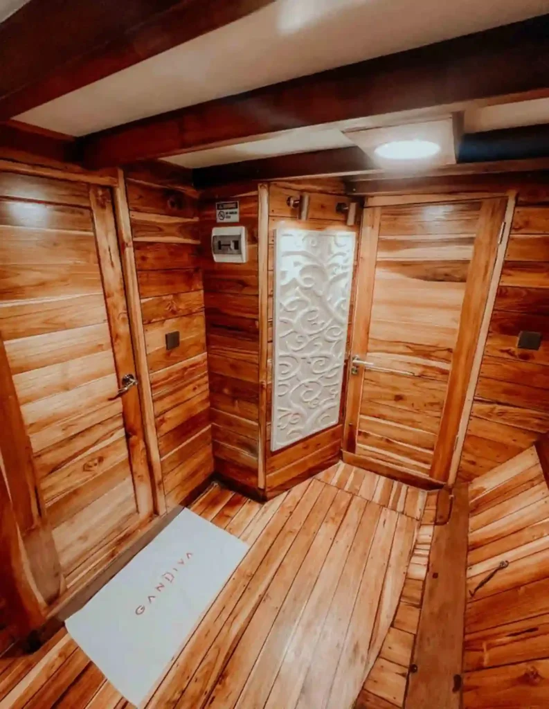 Wood-lined interior passage aboard Gandiva Phinisi