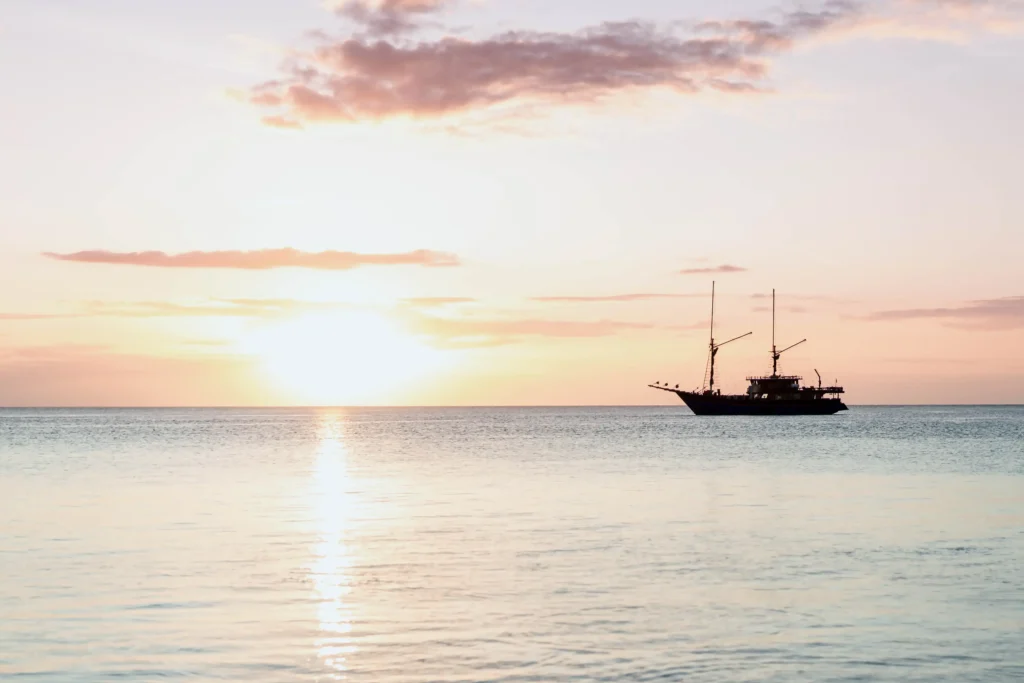 Silhouette of Iliké liveaboard at sunset