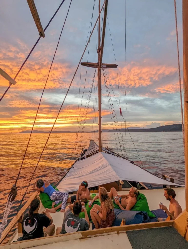 Guests relaxing on the deck of Jaya at sunset