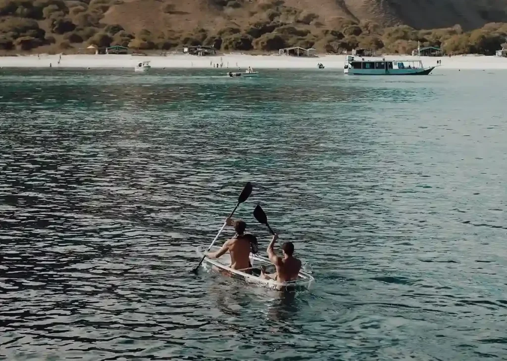 Two guests kayaking in a calm bay during a Lamborajo 3 charter