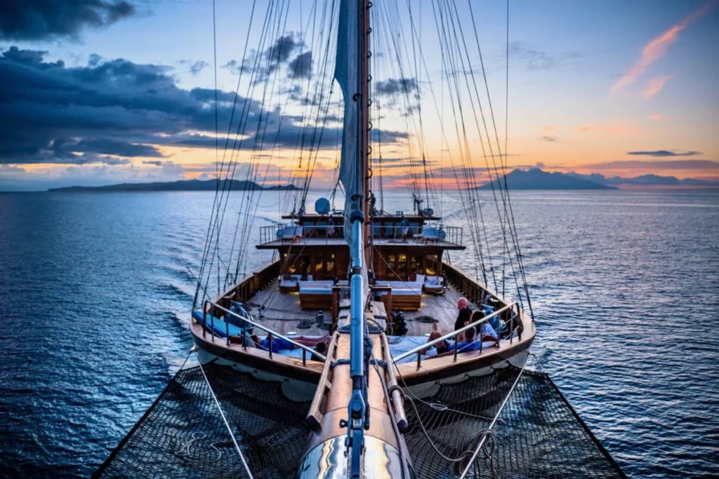 Lamima phinisi under sail at sunset