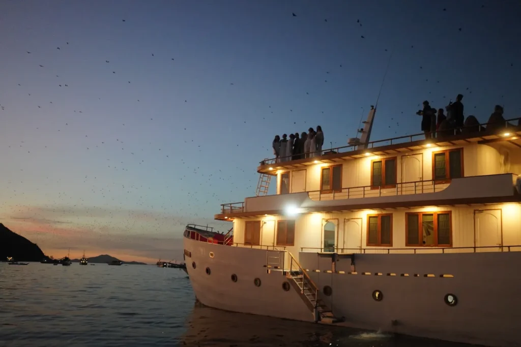 Phinisi liveaboard anchored off Kelor Island on the first afternoon of a 3 days 2 nights Komodo tour