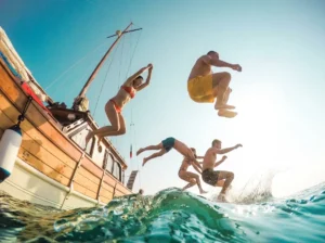 Passenger jumping from a phinisi boat during a Lombok to Komodo boat trip