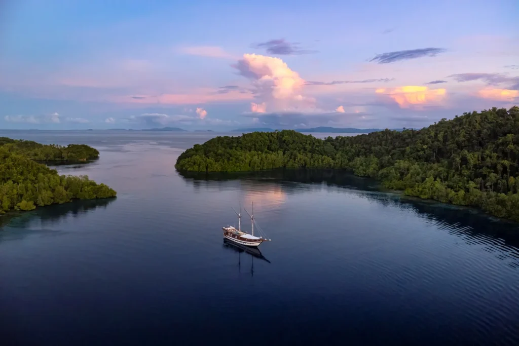 Majik anchored among islands at sunset