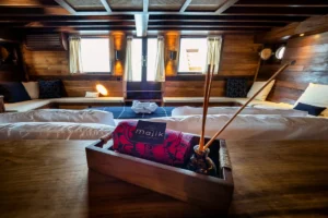 Bed and sofa in the Master Deluxe Cabin aboard Majik