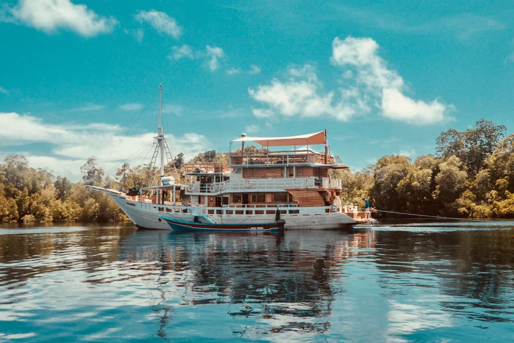 Starboard exterior of Mikumba Dua in an island anchorage
