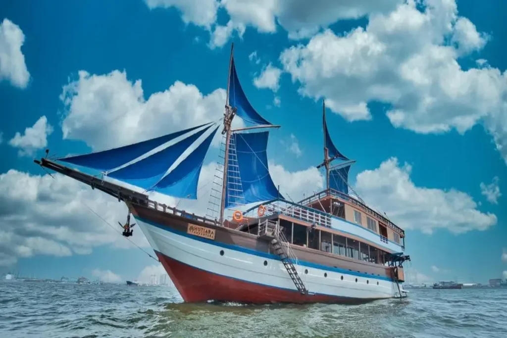 Mutiara Cruise under sail with both masts rigged off Komodo