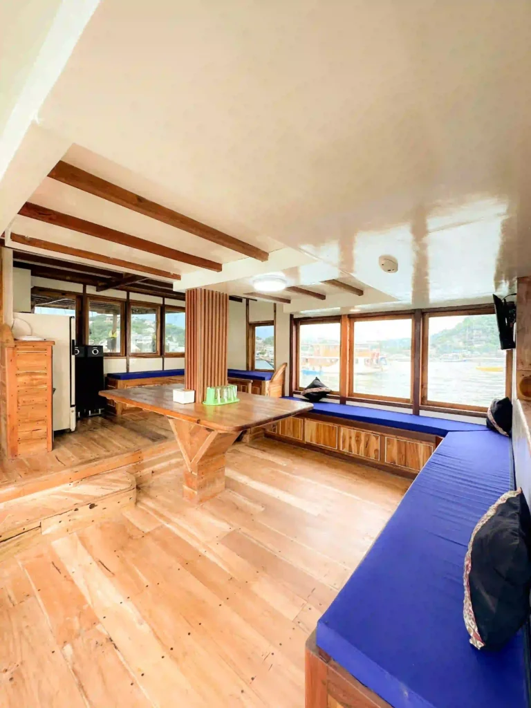 Indoor dining area aboard Natural Phinisi