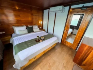 Deluxe cabin aboard Neptune Cruise with queen bed and sea-view windows