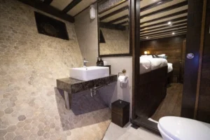 Private bathroom in a lower-deck double cabin aboard Nusa Kembara
