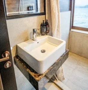 Private bathroom serving a twin cabin aboard Nusa Kembara