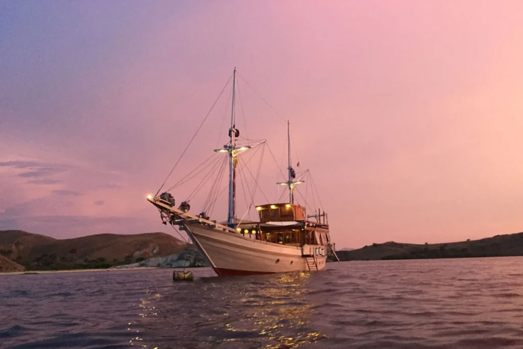 Nyaman phinisi at anchor at sunset in Komodo