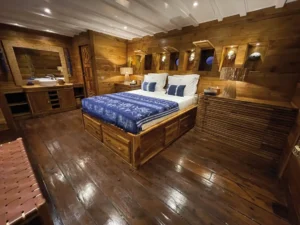 Double-bed guest suite with portholes aboard Ocean Pure 1
