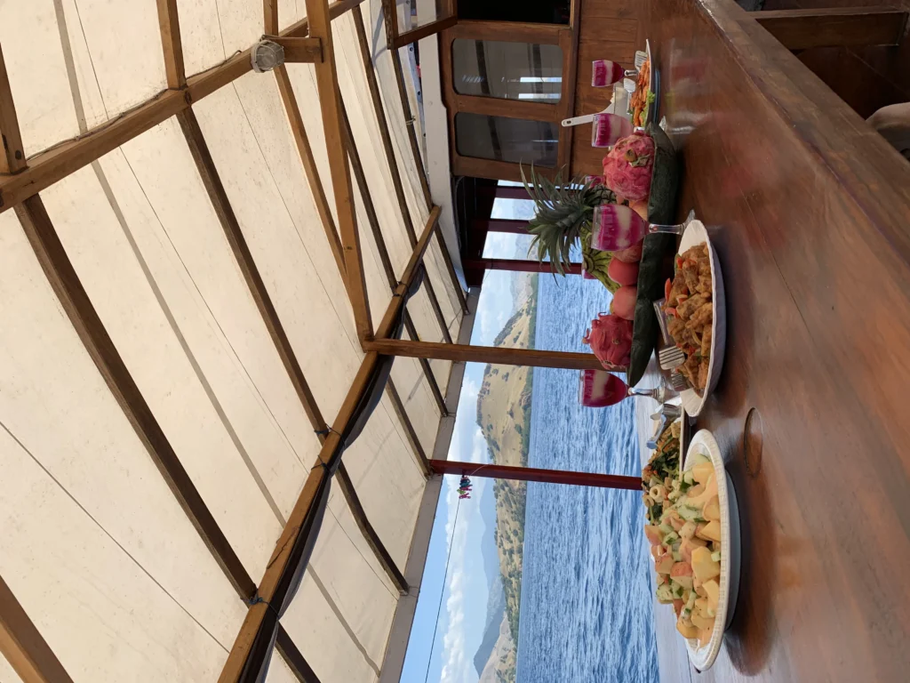 Outdoor dining table set aboard Queenesia I