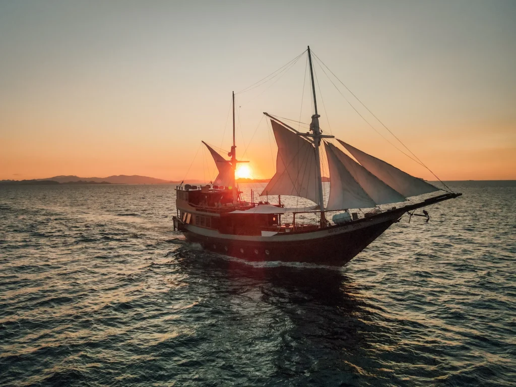 Queenesia II Buginese phinisi under sail at sunset
