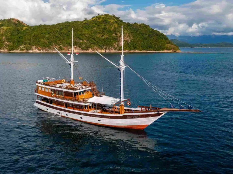 Revfiero phinisi viewed from the water in Komodo