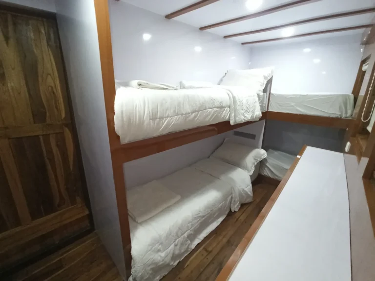 Second view of the four-berth shared bunk cabin aboard Riley phinisi