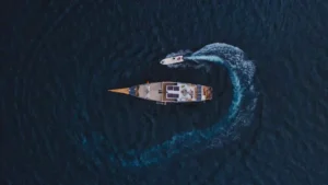 Top-down aerial view of Semesta Voyages turning and leaving a curved wake