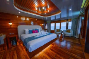 Upper-deck master cabin on Seven Angel with a double bed and access to the private balcony