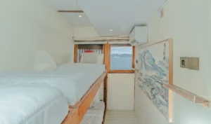 Upper-deck sharing cabin aboard Sora phinisi with single bunk beds