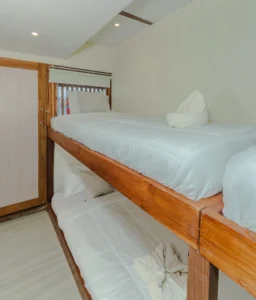 Upper-deck sharing cabin aboard Sora phinisi with single bunk beds